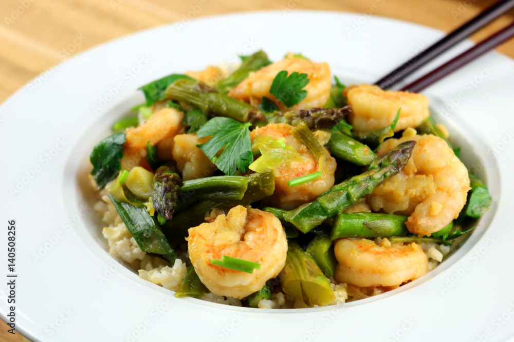 A bowl of freshly made shrimp and asparagus stir-fry A bowl of freshly made shrimp and asparagus stir-fry