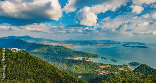 Panoramic view of blue sky, sea and mountain seen from Cable Car viewpoint, Langkawi, Malaysia. Picturesque landscape with beaches, small Islands and tourist ships at waters of Strait of Malacca