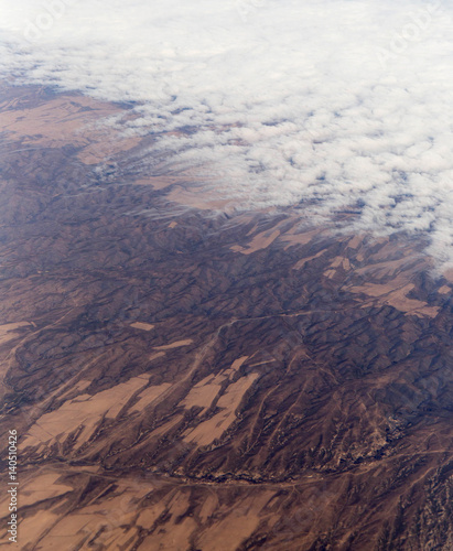 Clouds mountains and sky as seen through window of an aircraft of uzbekistan