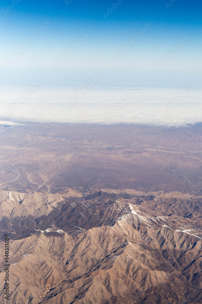 Clouds mountains and sky as seen through window of an aircraft of uzbekistan Clouds mountains and sky as seen through window of an aircraft of uzbekistan