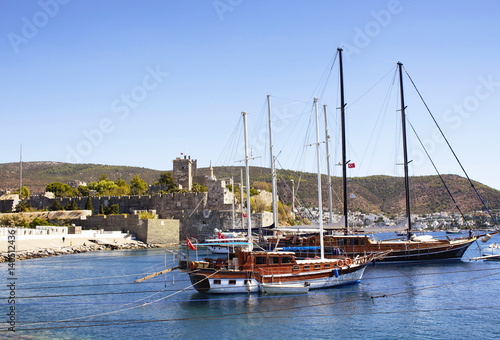 Luxury yachts (sailing boats) parked on turquoise water in front of Bodrum castle. The image shows Aegean and Mediterranean culture of coastel lifestyle. © theendup