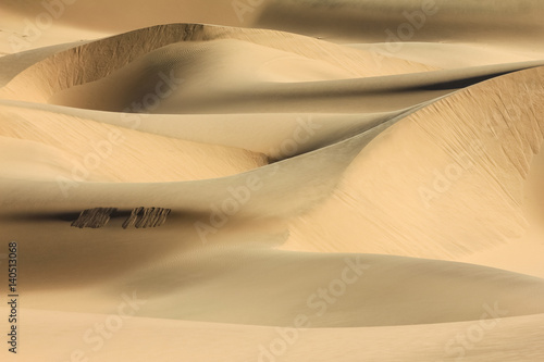 Big sand dunes. Desert or beach sand textured background. © Drepicter