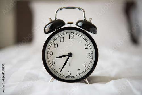 alarm clock on bed