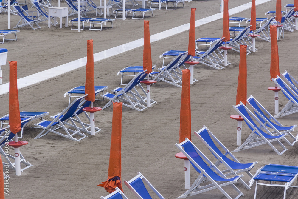 Naklejka premium Empty beach chairs early in the morning