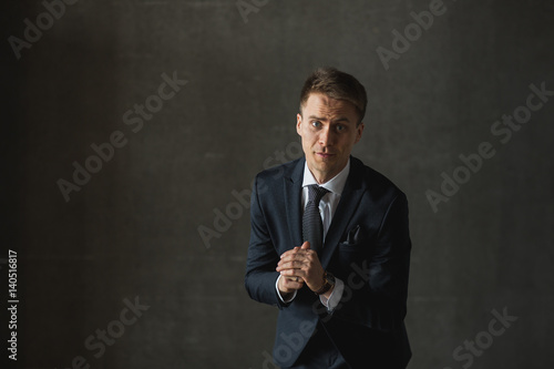 young businessmen in black suit emotional posing