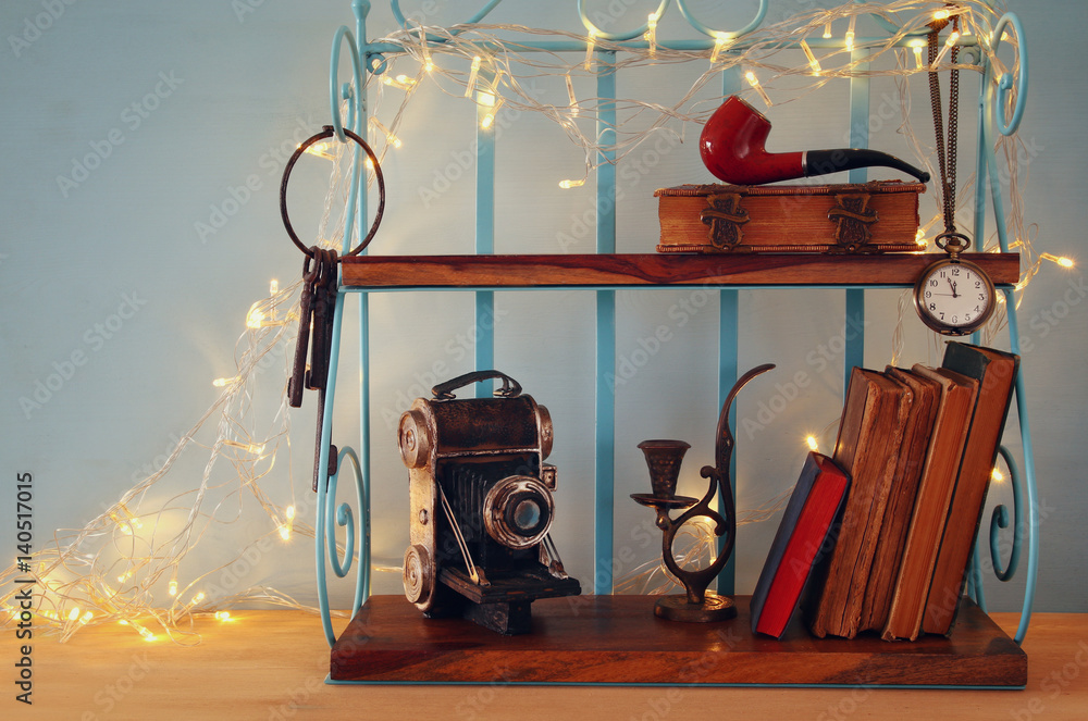 Classical shelf with vintage male objects, decorative old camera