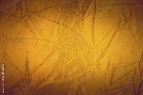 Gold thread on the fabric. Gold texture glitter background. Macro shot.