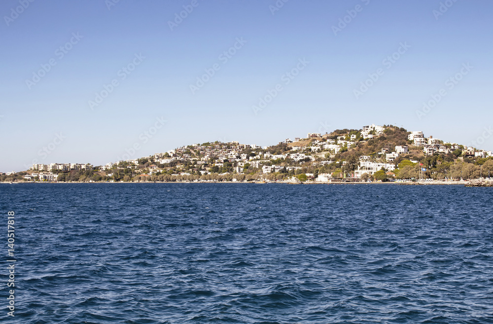 View of Aegean sea and summer houses in Yalikavak area in Bodrum Peninsula in a sunny summer day.