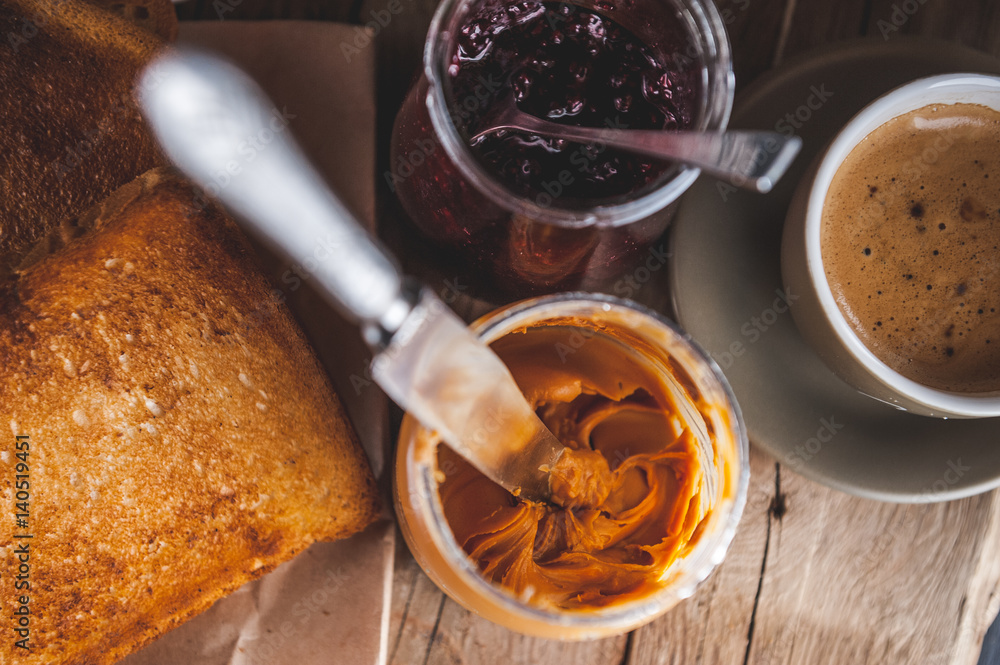 Peanut butter in a jar on the knife Peanut butter in a jar on the knife