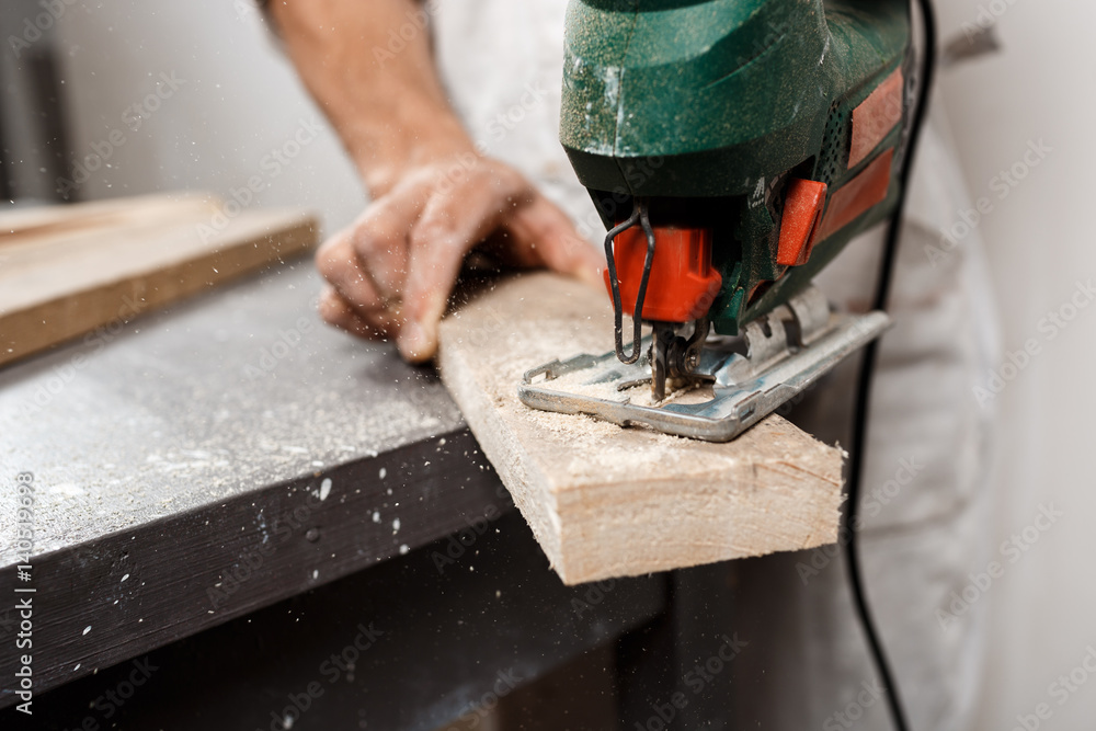 Close up photo of cutting wood with fretsaw. Close up photo of cutting wood with fretsaw.