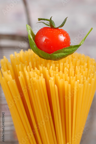 Close-up of a cherry tomato on pasta