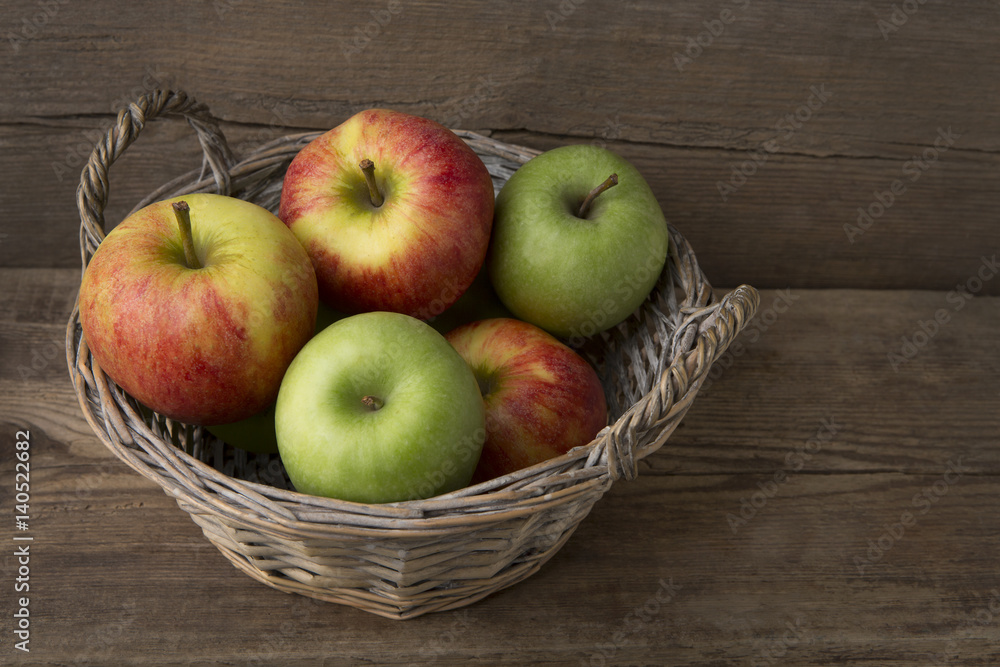 Basket of fresh apples on wooden background Basket of fresh apples on wooden background