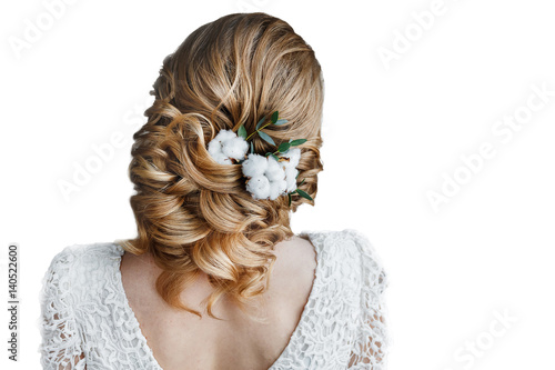 Portrait of attractive young woman with beautiful bridal hairstyle and stylish hair accessory of cotton flower isolated on white