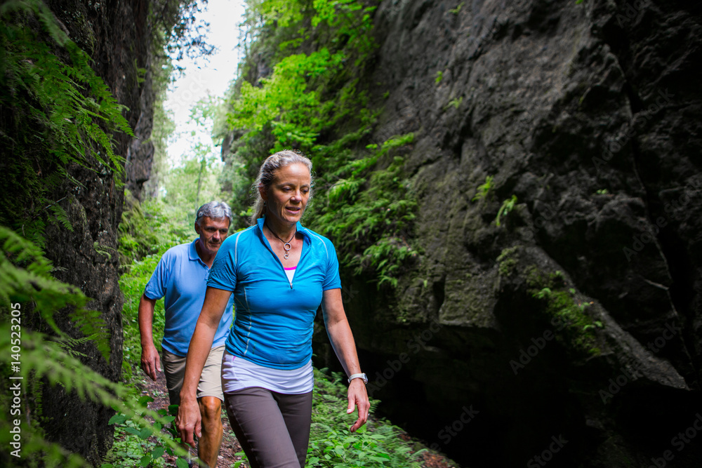 Older couple hiking in the forest Older couple hiking in the forest