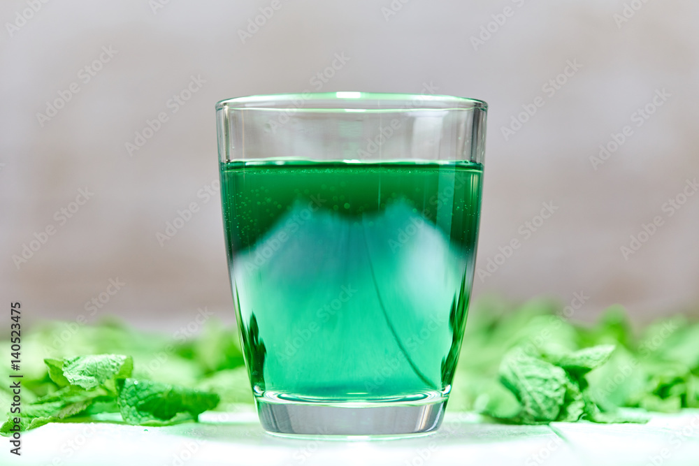Green chlorophyll drink in glass with water Green chlorophyll drink in glass with water