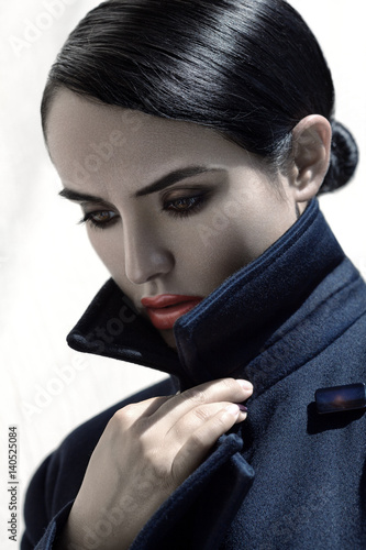 Fashion portrait of young beautiful brunette girl with stylish makeup.