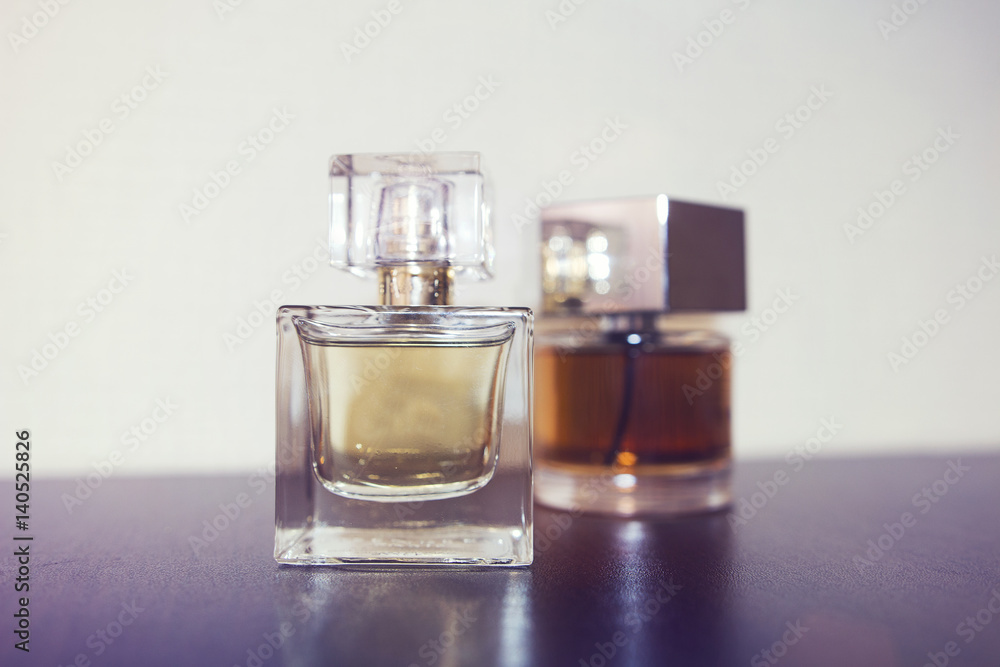 Two bottles of perfume on the table. Two bottles of perfume on the table.