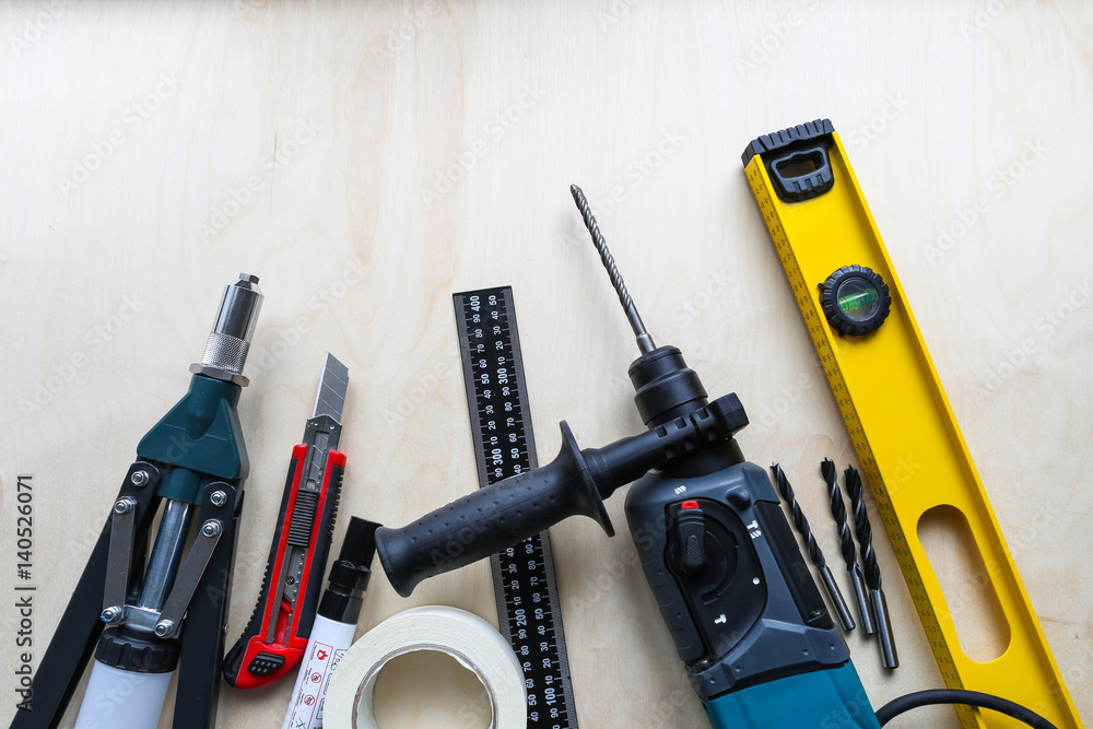 Assorted Tools on Plywood Background and Free Space for Text