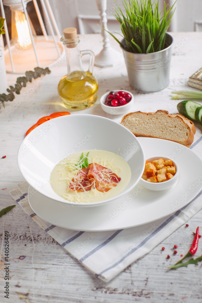 Cream soup with parmesan and bacon and crackers Cream soup with parmesan and bacon and crackers