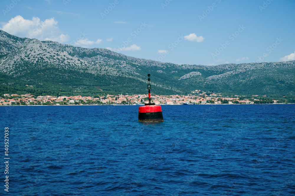 Obraz premium Isolated danger mark in Mljet Channel. Yachting, sailing, shipping concept.