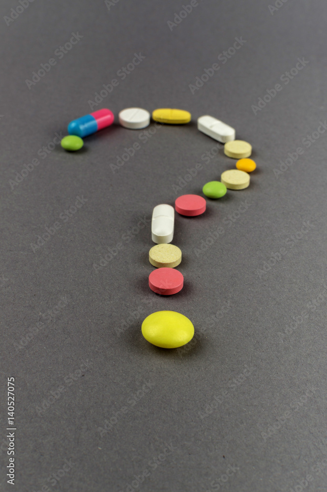 Question mark created from colored pills. Medical concept Question mark created from colored pills. Medical concept