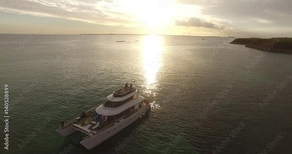 Aerial View of Boat Party with Sunset in Paradise Islands in Bahamas Aerial View of Boat Party with Sunset in Paradise Islands in Bahamas