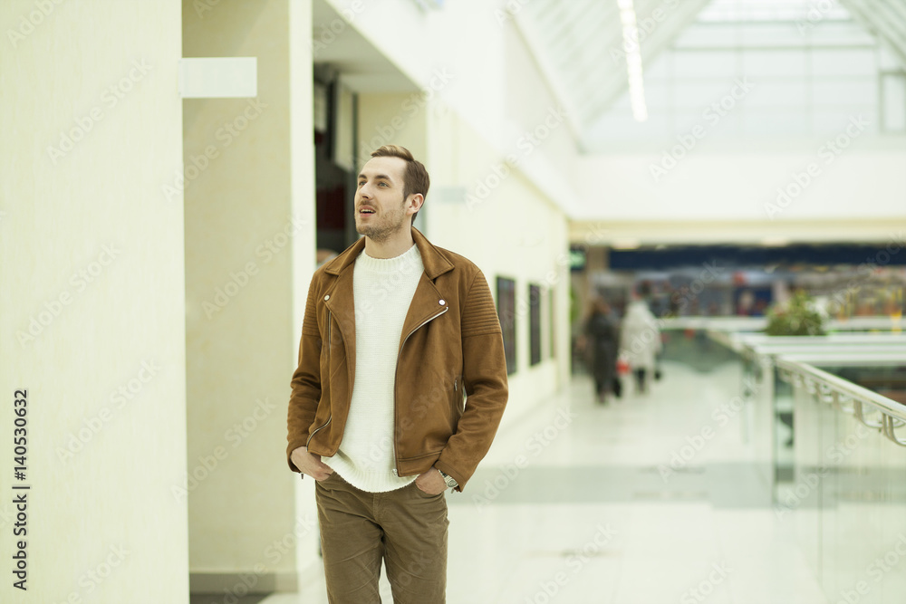 Fototapeta premium young guy walks through the Mall