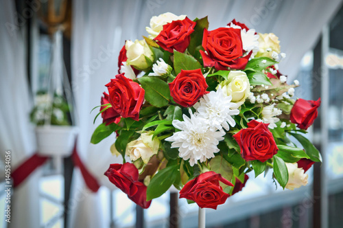 Bright colorful bouquet as table decorations, a bouquet of red roses and chrysanthemums,
