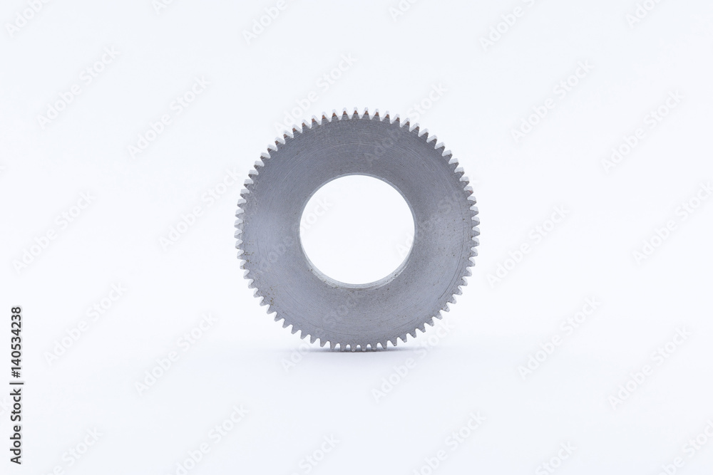 Isolated metal pinions gear. The iron gear on a white background. Pinions in the gearbox. Parts to the gear mechanism. Sprockets to clockwork. Shiny gear ready for assembly. Isolated metal pinions gear. The iron gear on a white background. Pinions in the gearbox. Parts to the gear mechanism. Sprockets to clockwork. Shiny gear ready for assembly.