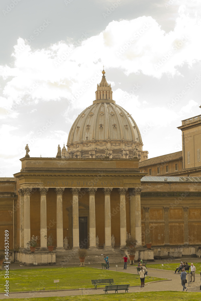 Dome of St. Peter's from the Vatican Museum. Courtyard of the Pinecone at Vatican Museums. The Vatican Museum is one of largest in the world with over 4 million visitors a year.
