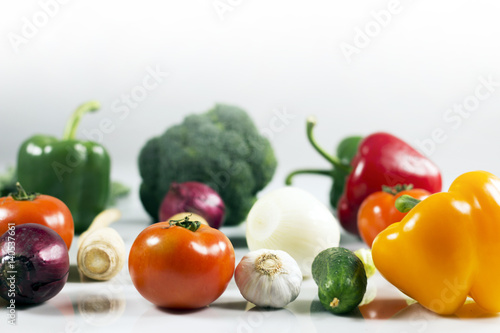 Young spring vegetables on black wood. Background with place for text