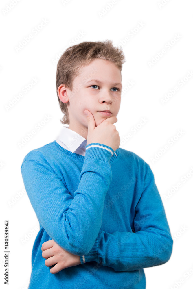 Young boy in blue pullover in pensive pose. Schoolboy isolated on white background. Young boy in blue pullover in pensive pose. Schoolboy isolated on white background.