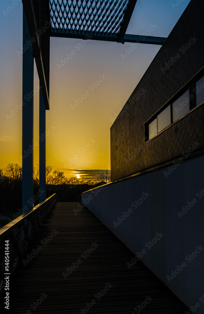 New modern building on yellow sunset background New modern building on yellow sunset background