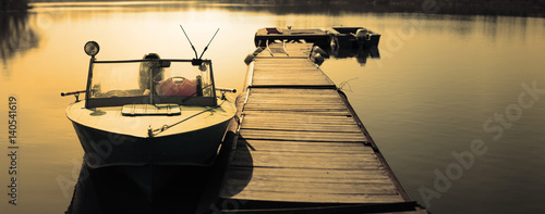 Obraz na plátně Lifeboat moored on a river pantone berth