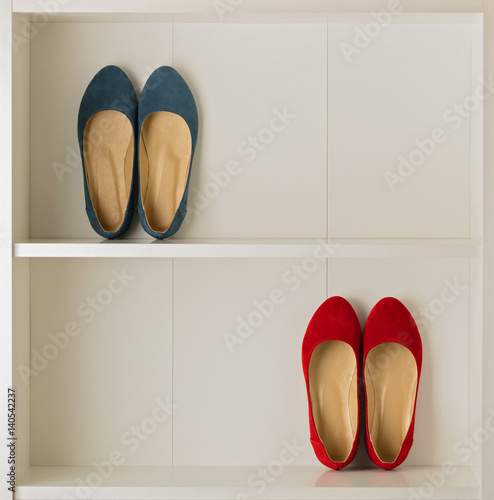 Women's shoes (ballet shoes) in the white wardrobe.