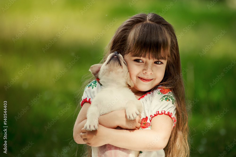 Little girl with a Golden retriever puppy Little girl with a Golden retriever puppy