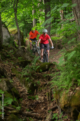 Couple Mountain Biking on Single Track in the Forest