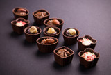 Assortment of chocolate candies on black background