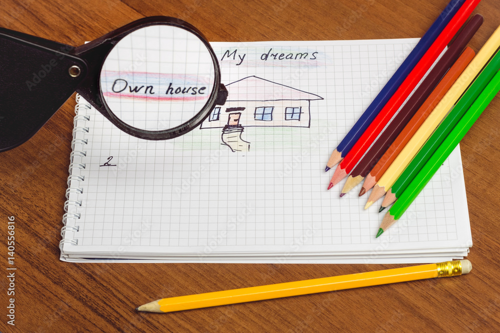 My dream own house written text and drawing on the notepad, color pencils on the table. concept of visualization future. My dream own house written text and drawing on the notepad, color pencils on the table. concept of visualization future.