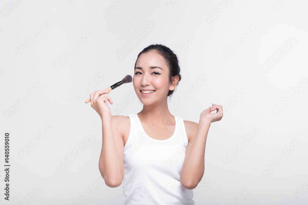Portrait of attractive young Asian woman with beautiful skin holding brush for make up. Portrait of attractive young Asian woman with beautiful skin holding brush for make up.