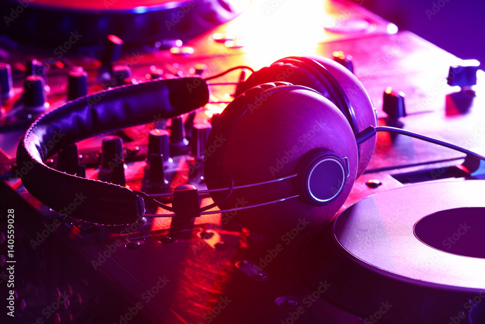 Headphones on dj mixer in nightclub
