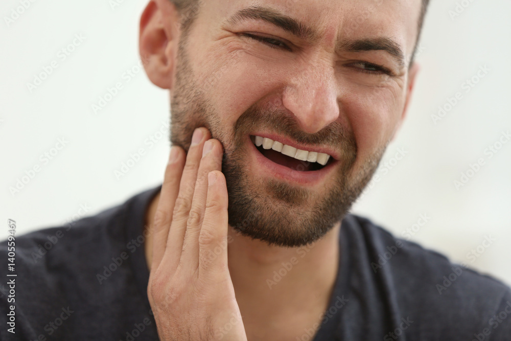 Handsome man suffering from toothache at home, closeup Handsome man suffering from toothache at home, closeup