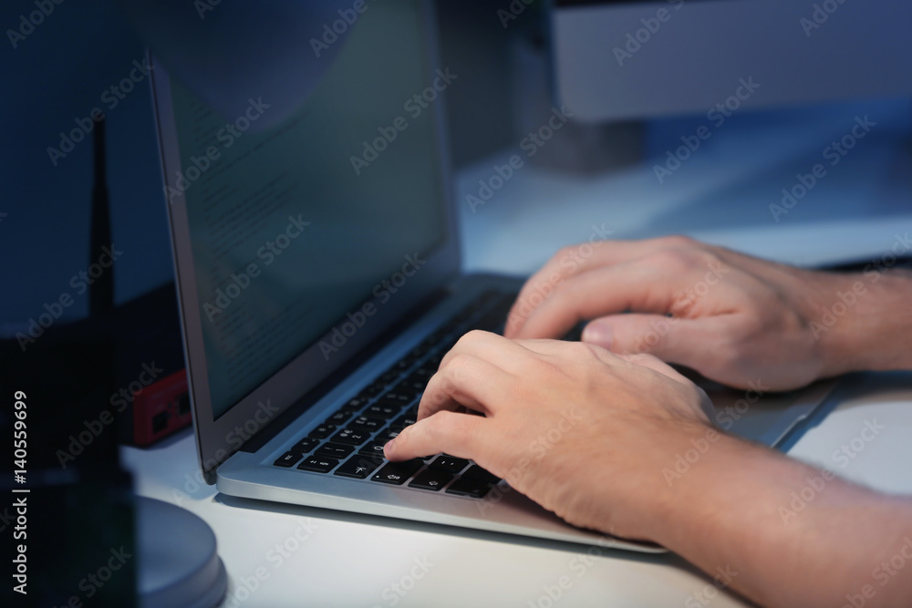Hands of programmer working at home late in evening, closeup Hands of programmer working at home late in evening, closeup