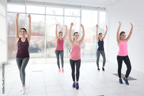 Young sporty women training in dance hall