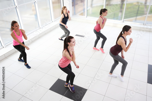 Young sporty women training in dance hall