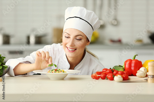 Female chef preparing in ki...