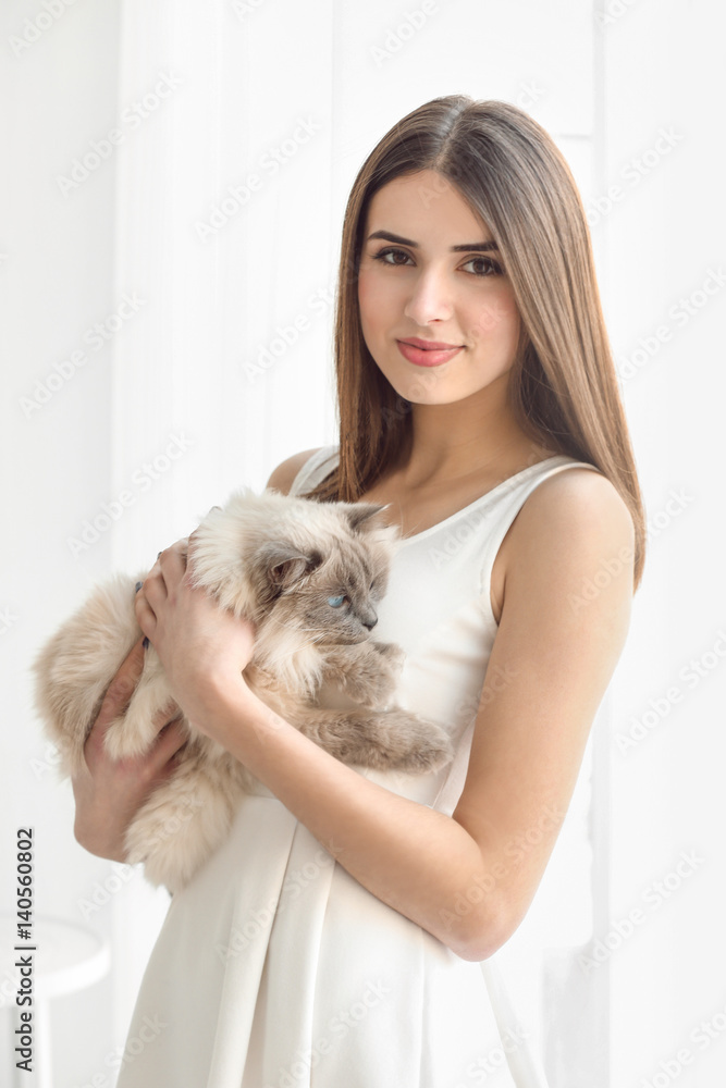 Beautiful young woman with cute cat resting at home Beautiful young woman with cute cat resting at home