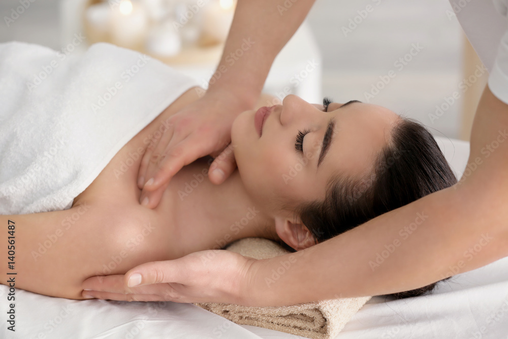 Beautiful young woman receiving massage in spa salon Beautiful young woman receiving massage in spa salon
