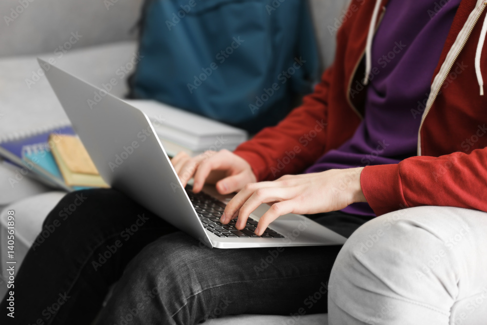 Teenager working with laptop at home, closeup Teenager working with laptop at home, closeup