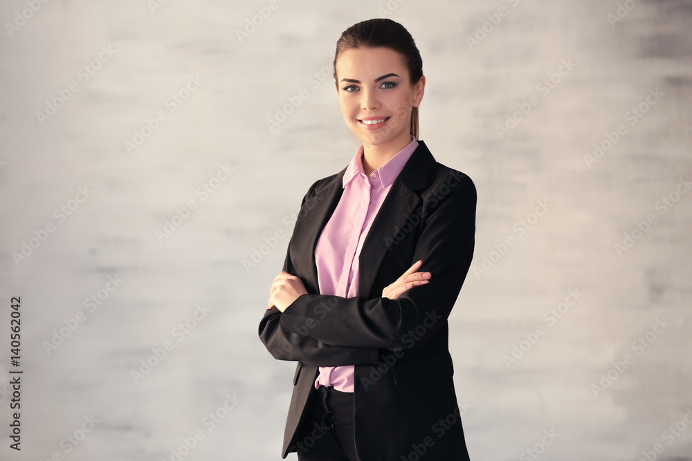 Confident young manager on blurred background Confident young manager on blurred background